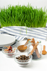 Vertical shot.Kitchen table and tableware, dishes, bowls with spices, fresh greens on it.Domestic kithcen table