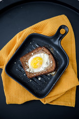 Avocado sandwich with fried egg. Egg on toasted bread for healthy breakfast or snack, copy space. Vegan avocado sandwiche top view close-up