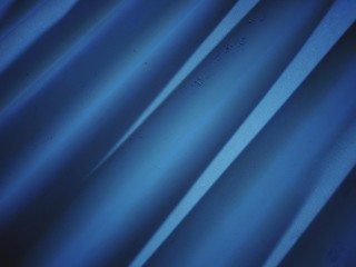 blue shiny corrugated metal texture with vignette