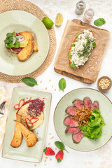 Several types of snacks, roast beef, salad, sandwich