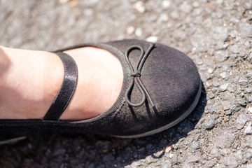 Detail of a black shoe with a buckle of a child