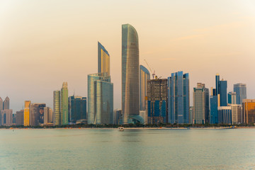 Fototapeta na wymiar Evening view of Abu Dhabi financial district skyline. Luxury lifestyle hotels and business of United Arab Emirates. 