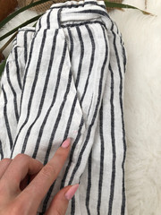 Dirty spot on white striped shorts closeup on white fur
