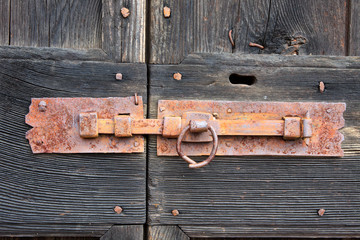 Cravegna (VCO), Italy - December 19, 2017: A door's bolt on an old house, Vigezzo Valley, VCO, Piedmon, Italy