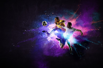 Boy playing soccer hitting the ball