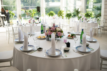 beautiful white interior in a restaurant with round tables