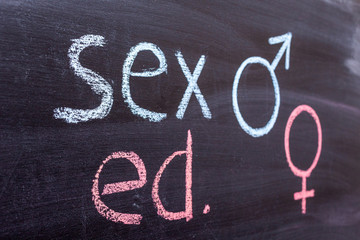 School blackboard with text SEX ED