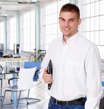 Young smiling businessman at startup office