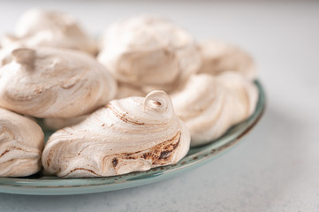 Homemade eggs dessert meringue on a plate on light background. Copy space