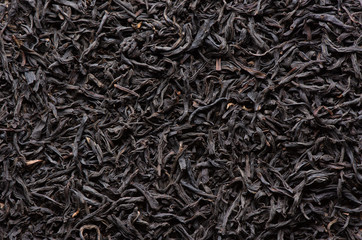 Dry black tea leaves background - obrazy, fototapety, plakaty