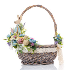 Fototapeta na wymiar Provence Easter flower arrangement with decorative wooden bunny on wicker basket on white background