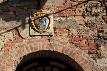 Asciano (SI), Italy - June 01, 2016: Typical wall and arc in Asciano, crete senesi, Tuscany, Italy