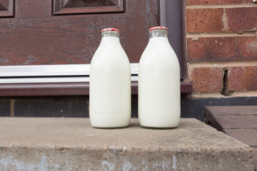 Fresh milk in recyclable glass bottles delivered to the door by a traditional milk man