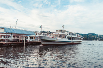 Fototapeta premium Cruise ship on lake Lucerne docking close to harbour overcast day 2019