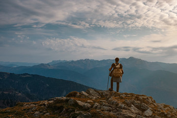 Young male hipster in the mountains in autumn