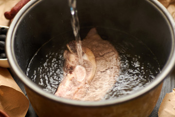 Cooking meat broth. Add water to the meat pan.