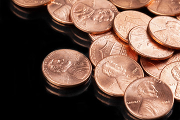 Close up of United States coins, pennies black background