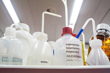 Set of empty plastic chemical bottles with straws in a lab environment Isopropyl isopropanol water...