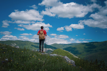 Traveler Man relaxing meditation with serene view mountains. Travel Lifestyle hiking concept summer vacations outdoor