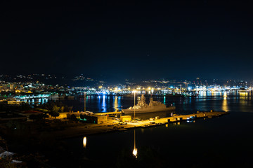 La Spezia Italy harbour port at night with military ships and city lights in the background