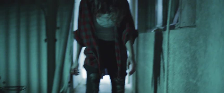 Zombie woman walking outside the building at night.Transformation zombie concept