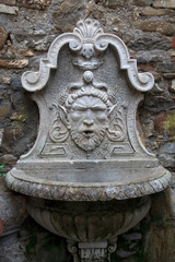 Dolceacqua (IM), Italy - December 19, 2017: An old fountain in Dolceacqua village, Imperia, Liguria, Italy