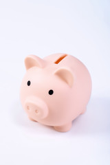 Financial concpet - Piggy bank, beautiful red white wooden house model on white background, saving money to buy insurance, close up, copy space.