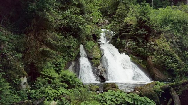 POV Walking toward beautiful waterfall in forest wilderness.Triberg Gutach river waterfall. Power of nature
