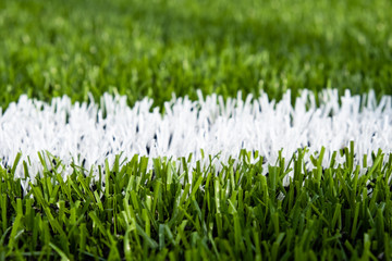 Artificial green grass on the football field