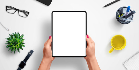 Tablet in woman hands with isolated screen for app or web site design presentation mockup. Top view, flat lay composition