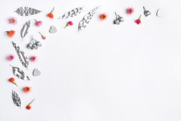 Fototapeta na wymiar Australian native eucalyptus silver leaves, gum nuts, hearts are decorated with purple & red flowering gum nuts, on a white background. To celebrate Valentines Day, Mothers day, birthday, Anniversary.