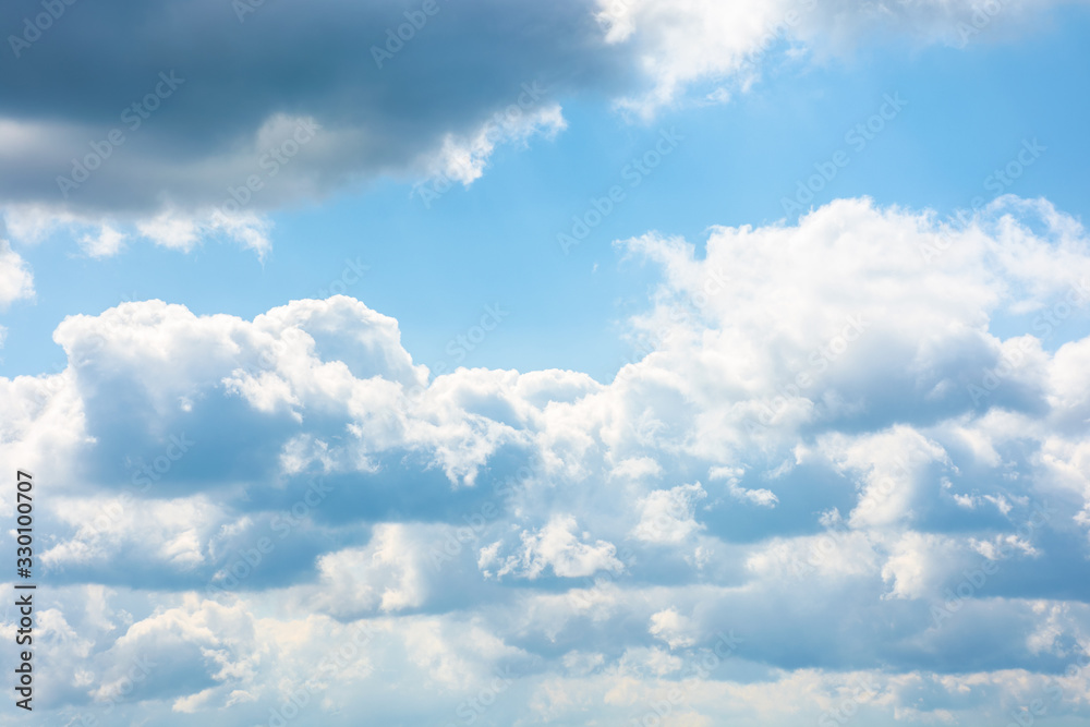 Wall mural gorgeous cloudscape in springtime. weather background with dynamic cloud arrangement on a blue sky. 