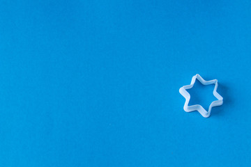 plastic molds for baking cookies in the form of stars on a blue background