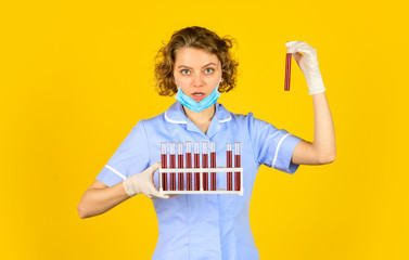 Medical professional developing vaccine. Coronavirus treatment. Doctor respirator mask. Infection vaccine and blood test. Medical worker testing tubes vaccination. Blood samples. Creating vaccine