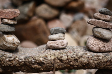 Three stacks of rock upon another rock