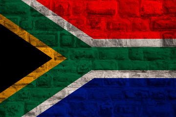 national flag of the modern state of South Africa on an old historical stone wall, concept of business, tourism, travel, emigration, globalization