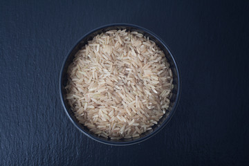A bowl of uncooked brown rice