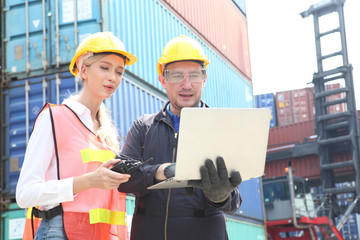 businessman or Foreman control loading Containers box from Cargo and inspector checking Containers box with shipping containers before departure for export business logistic company