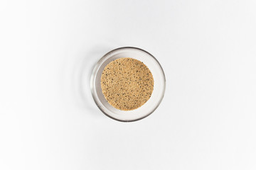 amaranth seeds heap in glass bowl isolated on white background