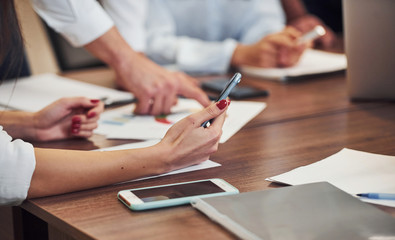 Close up view of business people that sitting and working together in the modern office