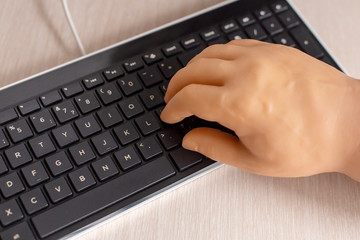 prosthetic hand and computer keyboard