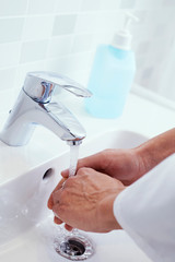 doctor man washing his hands in a sink