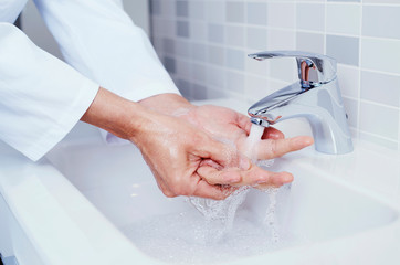 doctor man washing his hands in a sink