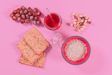 Obraz na płótnie Canvas Bowl of shredded hazelnuts with honey and crackers