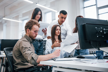 Group of young business people that working by computers in the modern office