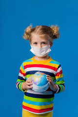 Fototapeta na wymiar children girl in medical mask on blue isolate background. concept of protection against coronavirus