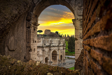 Arch of Constantine and the Colosseum at sunset, Rome. Italy