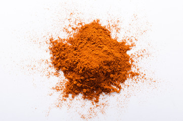 Top view of red pepper powder on the white background