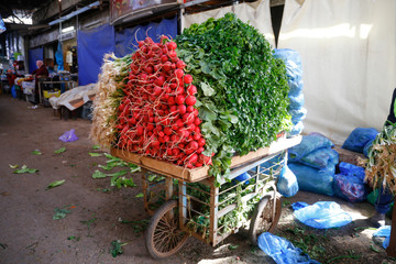 the vegetable cart in the center of Qalqilya city, Palestinian Territories. Parsley, red radish,...