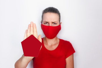 mock-up. woman in protective sterile medical mask her face white background, show palms, hands, stop without a sign. Air pollution, virus, Chinese concept of pandemic coronavirus. Focus on the hand.